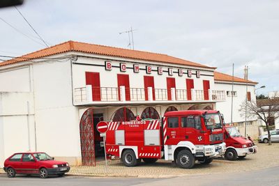 Cars on road against buildings in city