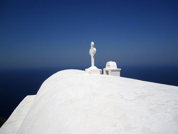 View of white cross against blue sky