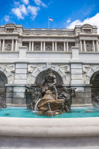 Statue of fountain in front of building