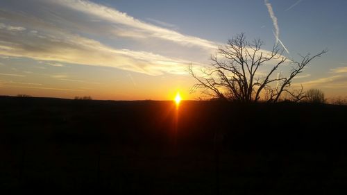 Silhouette landscape against sky during sunset