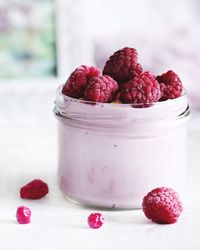 Close-up of strawberries in glass jar on table