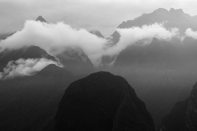 Scenic view of mountains against cloudy sky