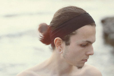 Close-up portrait of young man looking away