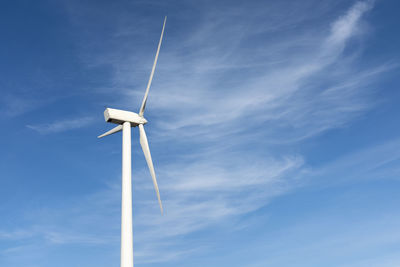 Wind turbine against blue sky