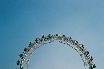 Ferris wheel against clear blue sky