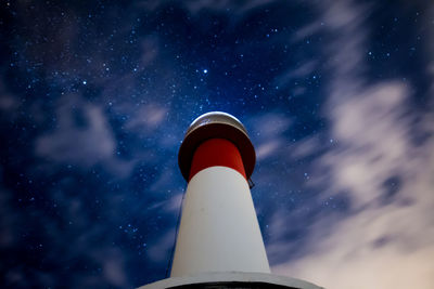 Low angle view of far del fangar lighthouse against sky at night