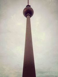 Low angle view of tower against cloudy sky