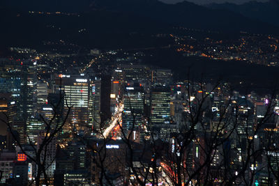 High angle view of city lit up at night