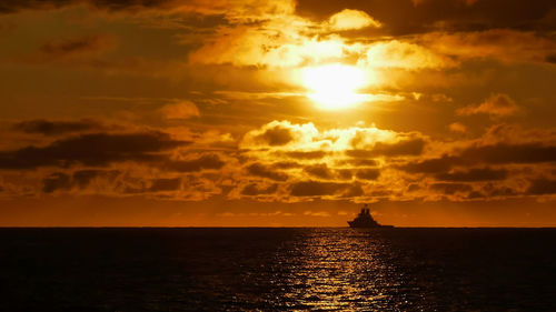 Scenic view of sea against orange sky