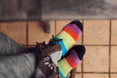 Low section of woman wearing colorful sock