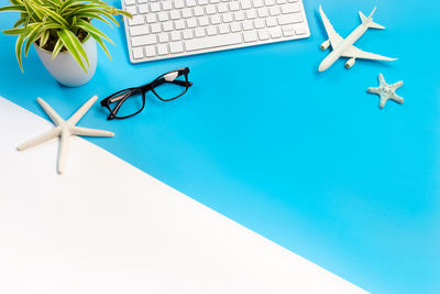 High angle view of eyeglasses on table against blue background