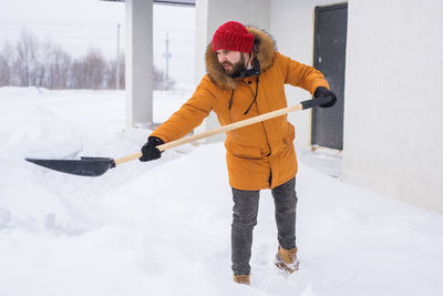 Low section of man skiing on snow