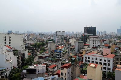 High angle view of buildings in city against sky