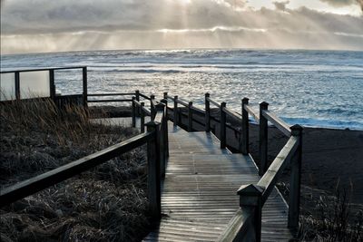 Pier over sea against sky