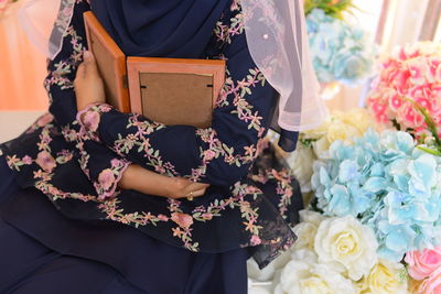 Close-up of woman holding bouquet