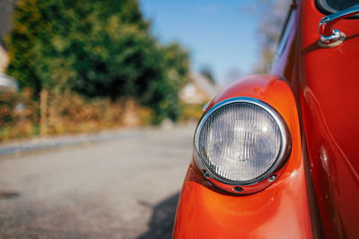 Close up of orange oldtimer on street