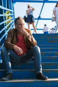 Man thinking and sitting on stairs