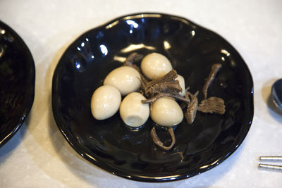 High angle view of boiled eggs with beef in bowl on table