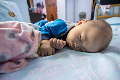 Cute baby sleeping on bed