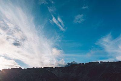 Low angle view of mountains against blue sky