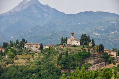 Scenic view of barga in front of mountains against sky