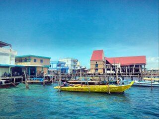 Calm blue sea with buildings in background