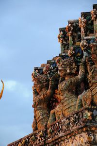 Low angle view of statues against clear sky