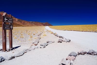 Scenic view of desert against clear blue sky