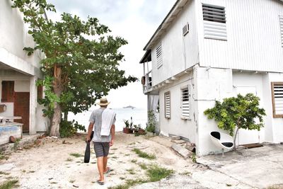 Rear view of man walking on built structure