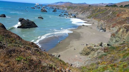 High angle view of people on ocean beach against sky