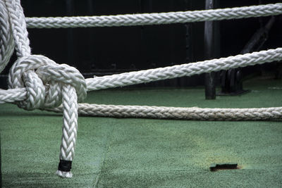 Close-up of rope tied to metal chain