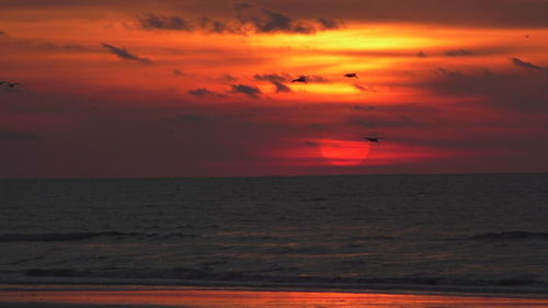 Scenic view of sea against orange sky