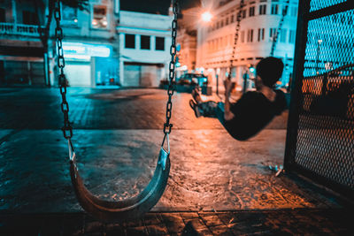 Woman on illuminated city street at night