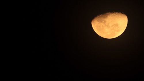 Low angle view of moon against clear sky at night