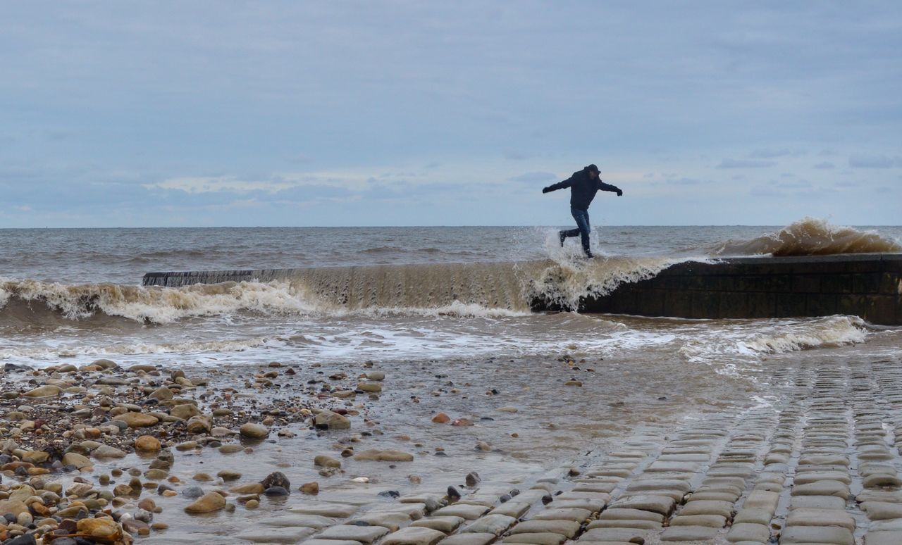 sea, water, sky, beach, land, one person, horizon over water, horizon, motion, real people, lifestyles, leisure activity, beauty in nature, nature, wave, scenics - nature, standing, men, outdoors