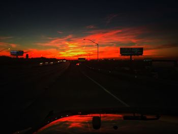 Cars on road at sunset