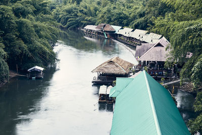 High angle view of river amidst trees and buildings in forest