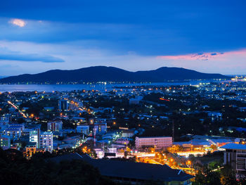 High angle view of illuminated city against sky at night