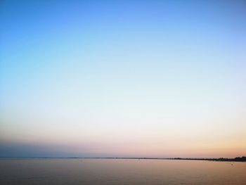 Scenic view of sea against clear sky during sunset