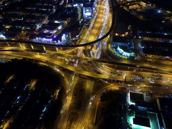 High angle view of light trails on bridge in city at night