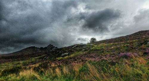 Scenic view of mountains against cloudy sky