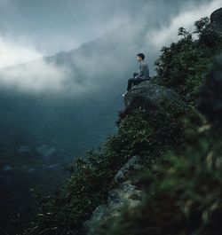 Scenic view of mountains against cloudy sky