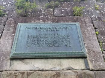 High angle view of text on stone at cemetery