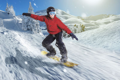 Full length of person skiing on snow covered mountain