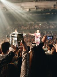Women filming with smart phones in music concert