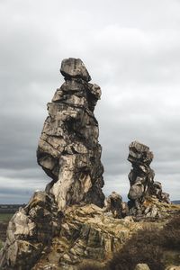 Low angle view of rock formation against sky