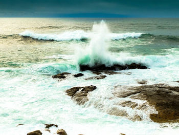 Waves breaking against sea