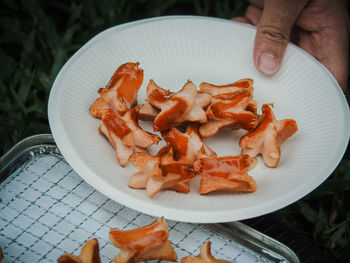 High angle view of person preparing food in plate on table