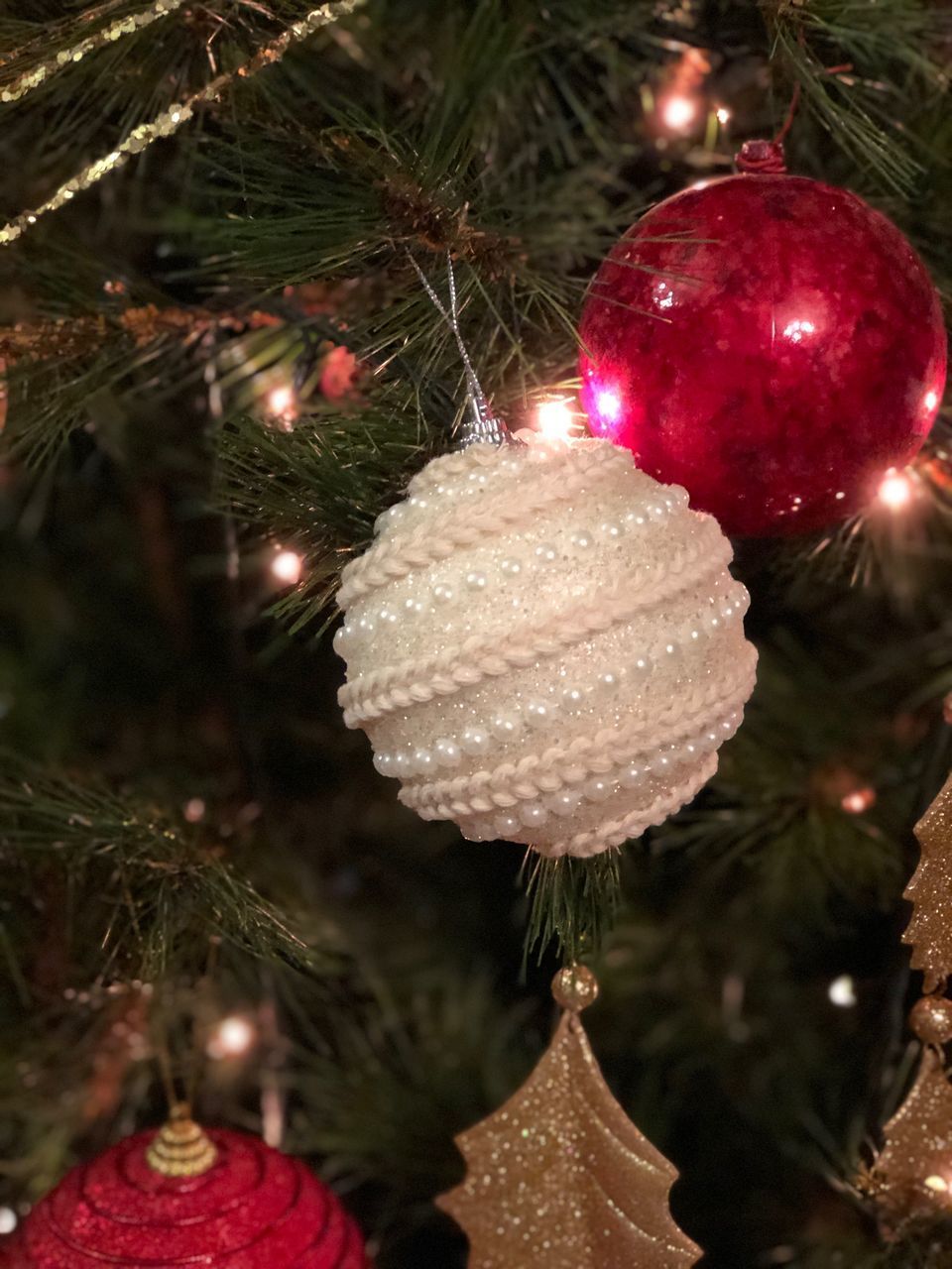 CLOSE-UP OF ILLUMINATED CHRISTMAS TREE AT NIGHT