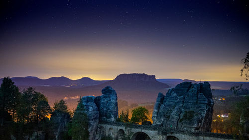 Scenic view of mountains against sky at night